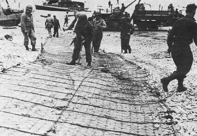 Engineers anchor reinforced track for vehicles coming ashore at OMAHA