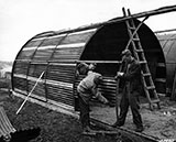 Men in Ireland constructing a steel hut